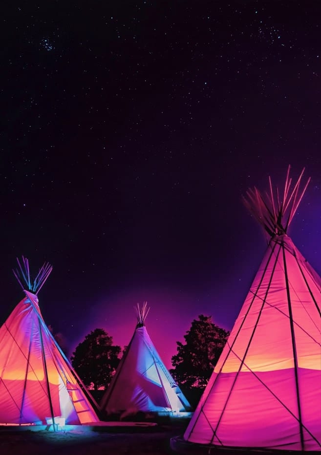 Teepees Glowing At Night Under The Stars By Tom Windeknecht