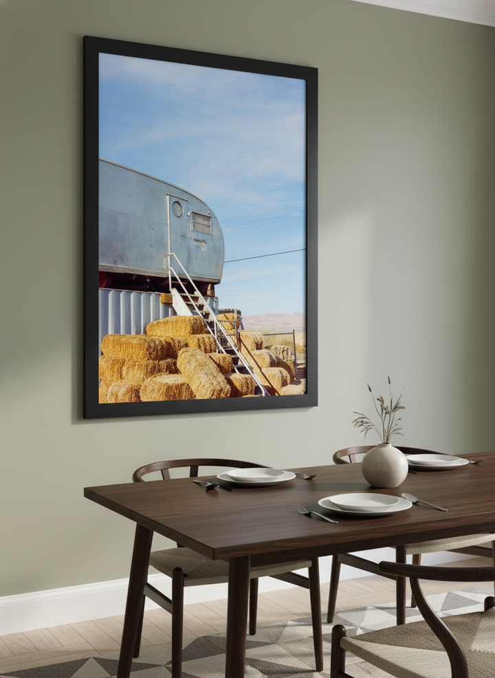 Wall art styled above a dining table in a contemporary home