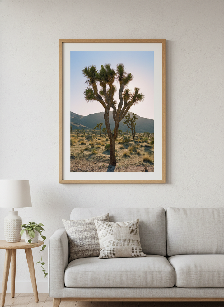 Modern wall art styled above a sofa in a neutral living room