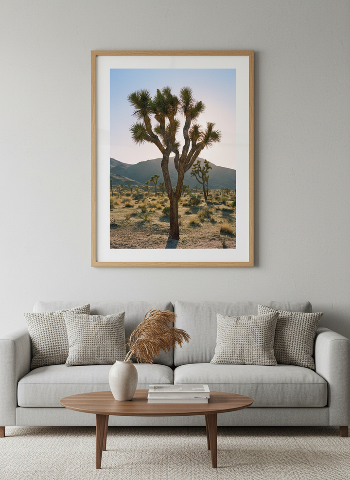 Modern wall art styled above a sofa in a neutral living room