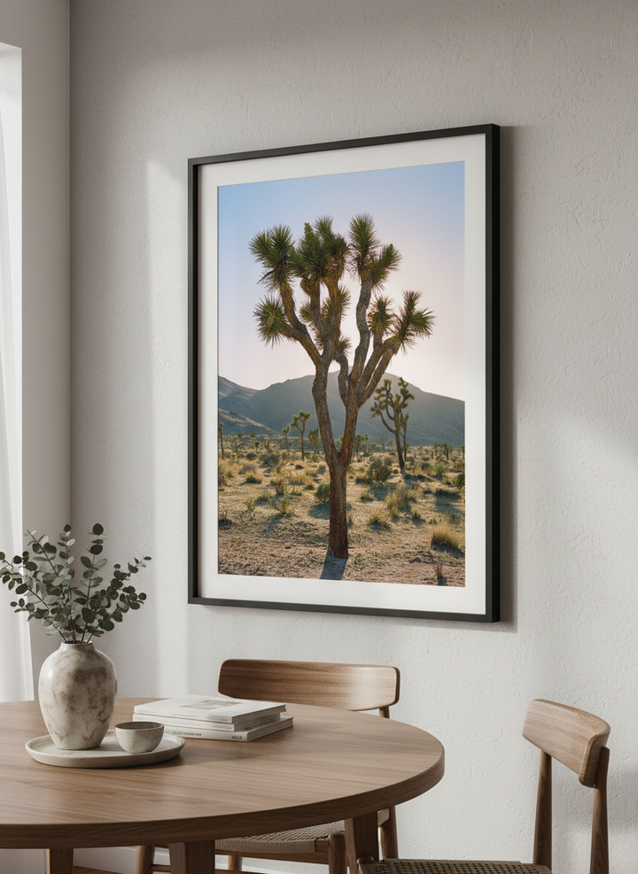 Wall art styled above a dining table in a contemporary home