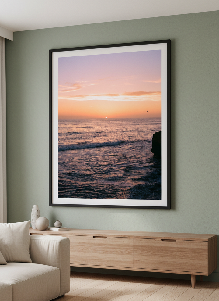 Modern wall art styled above a sofa in a neutral living room