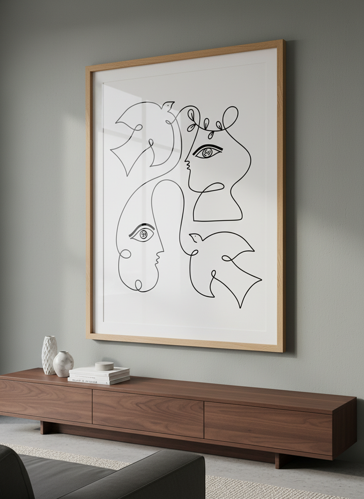 Modern wall art styled above a sofa in a neutral living room