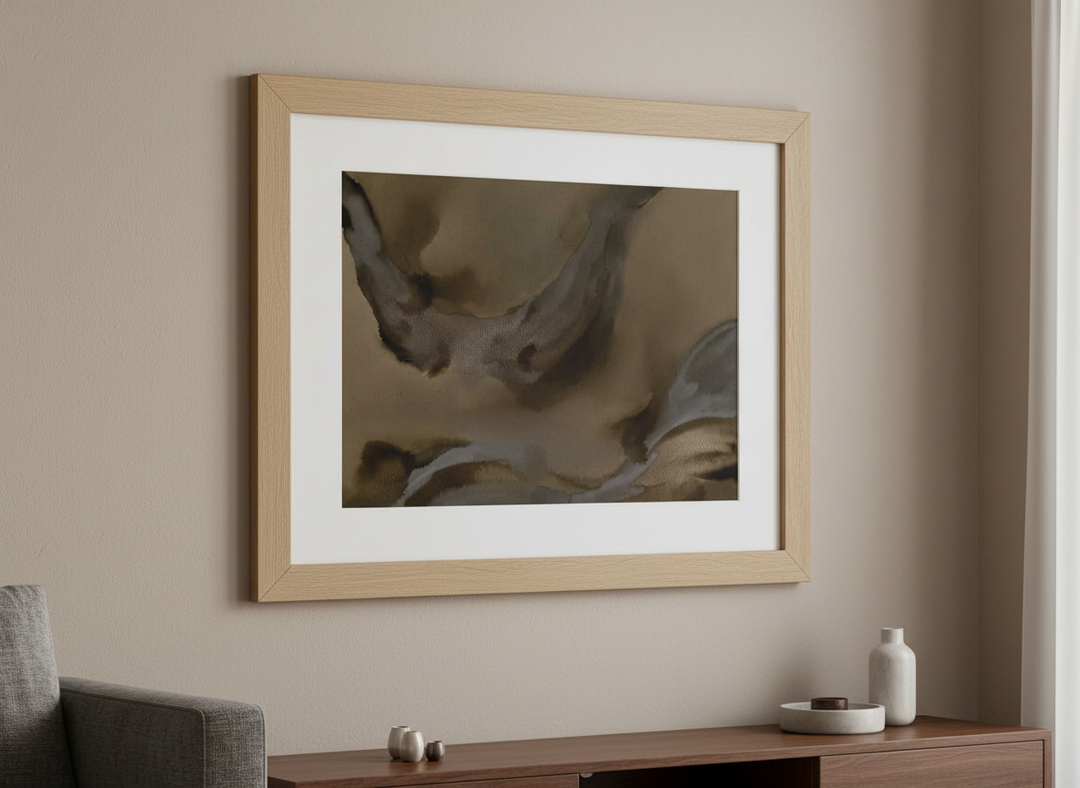 Modern wall art styled above a sofa in a neutral living room