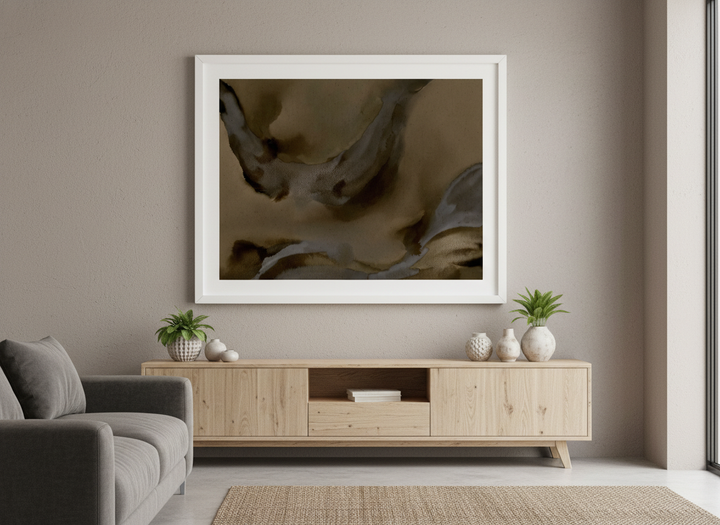Modern wall art styled above a sofa in a neutral living room