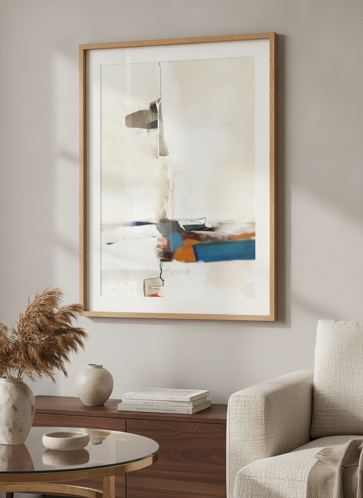 Modern wall art styled above a sofa in a neutral living room