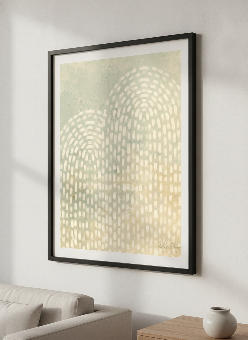 Modern wall art styled above a sofa in a neutral living room
