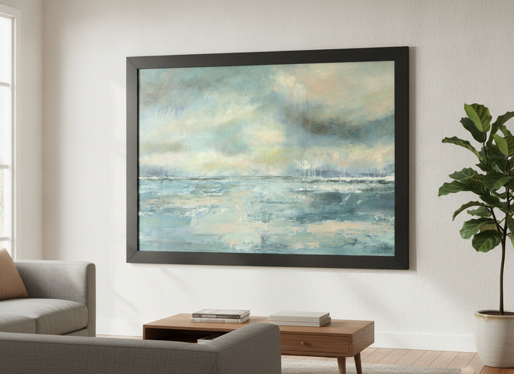 Modern wall art styled above a sofa in a neutral living room