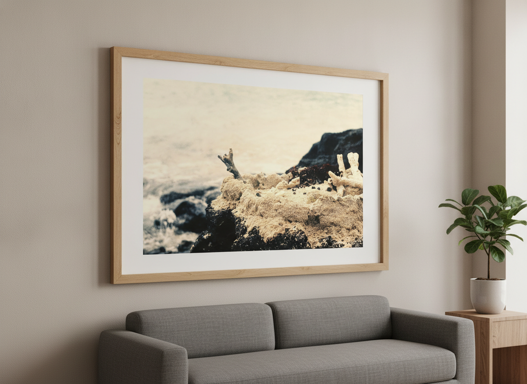 Modern wall art styled above a sofa in a neutral living room