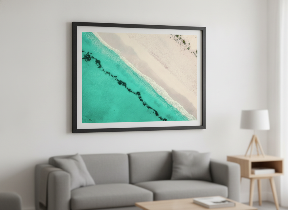Modern wall art styled above a sofa in a neutral living room