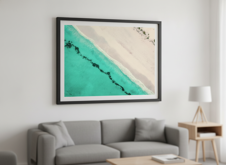 Modern wall art styled above a sofa in a neutral living room