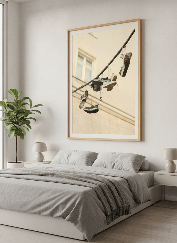 Minimalist artwork displayed in a calm, light-filled bedroom interior