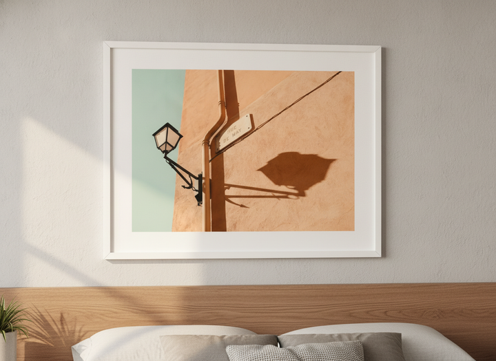 Minimalist artwork displayed in a calm, light-filled bedroom interior
