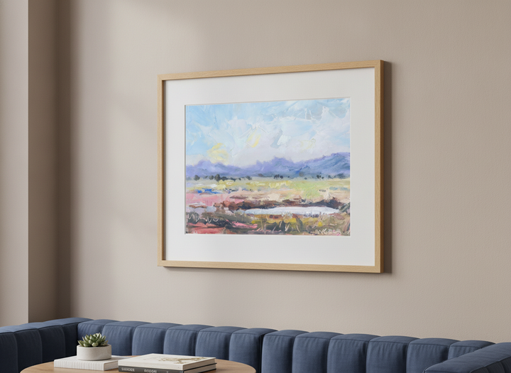 Modern wall art styled above a sofa in a neutral living room