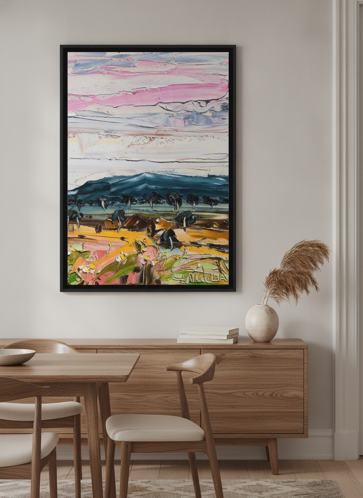 Wall art styled above a dining table in a contemporary home