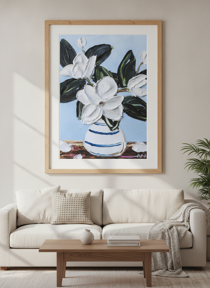 Modern wall art styled above a sofa in a neutral living room
