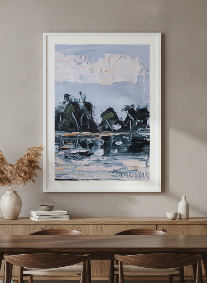 Wall art styled above a dining table in a contemporary home