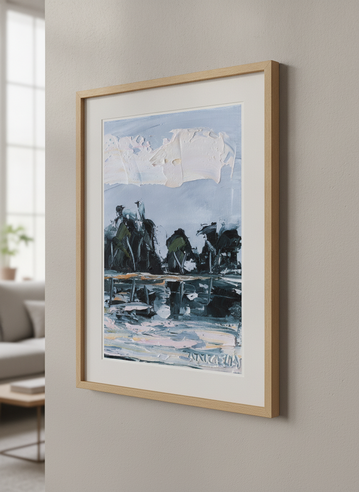 Modern wall art styled above a sofa in a neutral living room