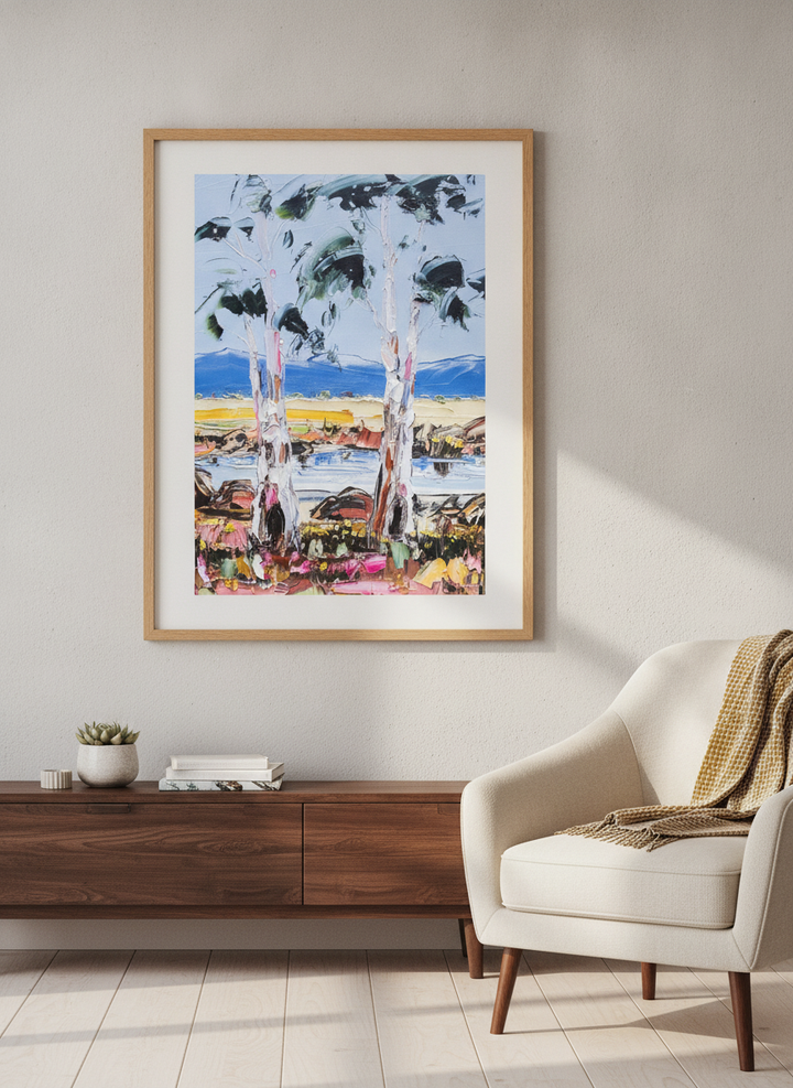 Modern wall art styled above a sofa in a neutral living room