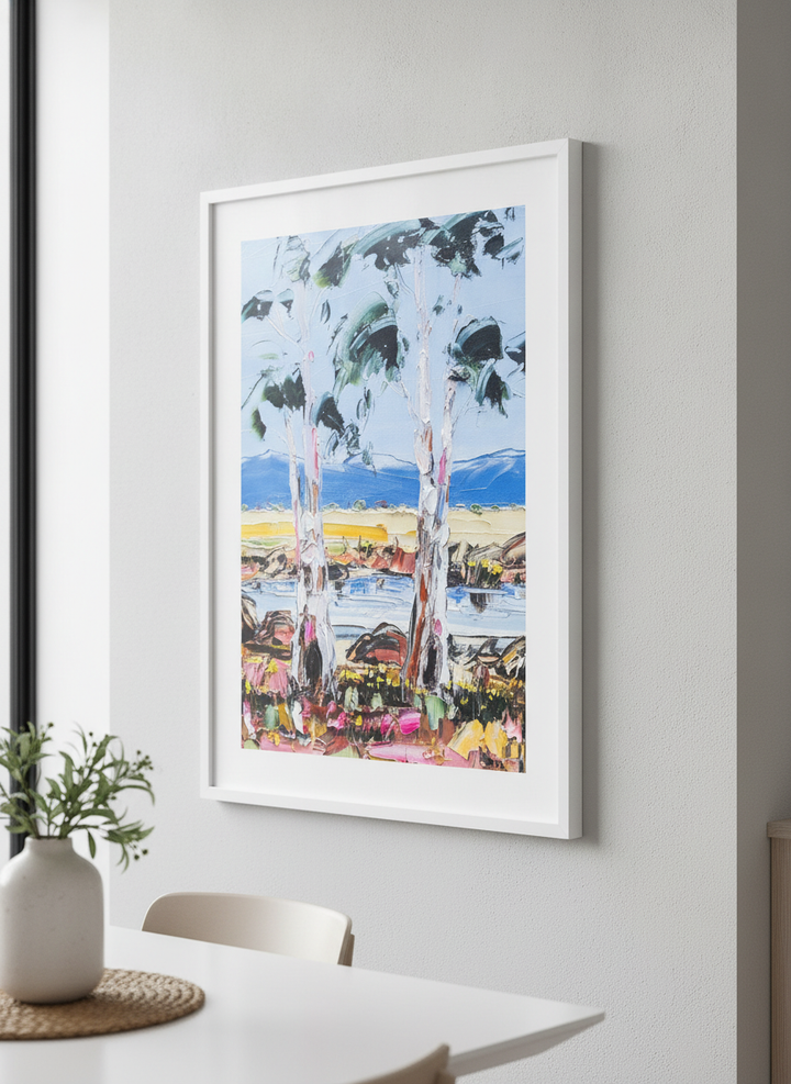 Wall art styled above a dining table in a contemporary home