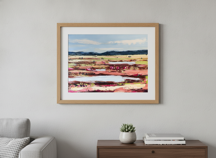 Modern wall art styled above a sofa in a neutral living room