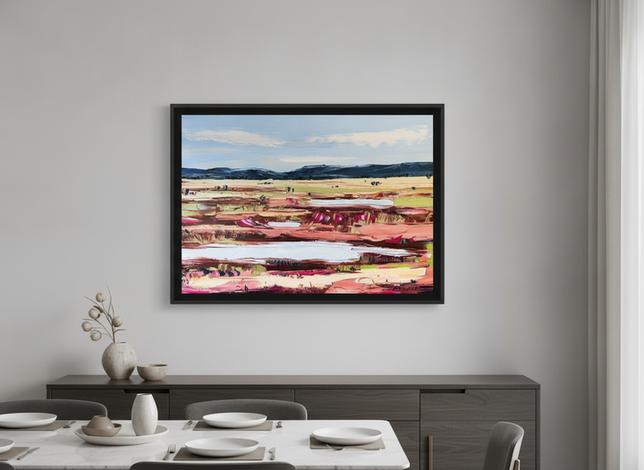 Wall art styled above a dining table in a contemporary home