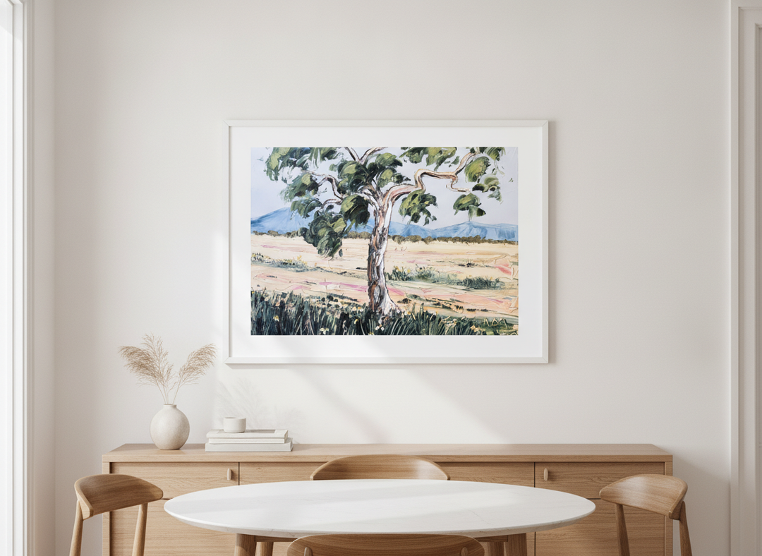 Wall art styled above a dining table in a contemporary home