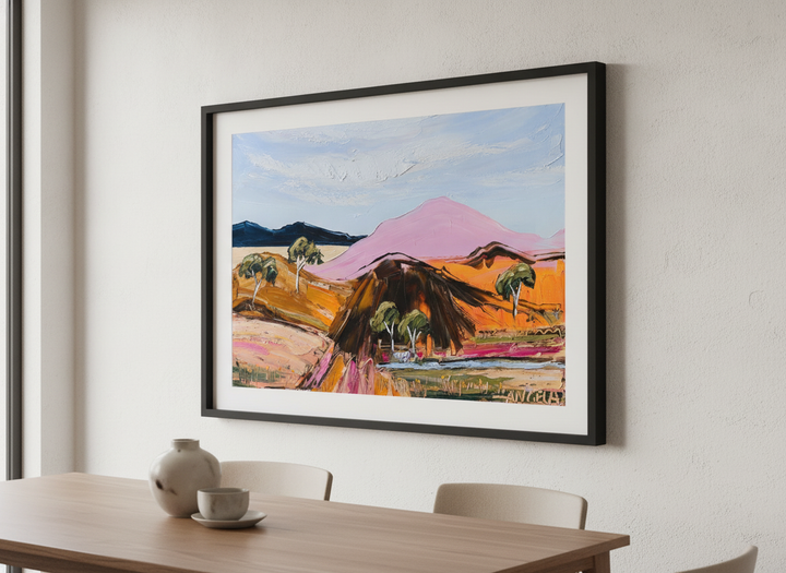 Wall art styled above a dining table in a contemporary home