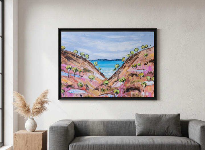 Modern wall art styled above a sofa in a neutral living room