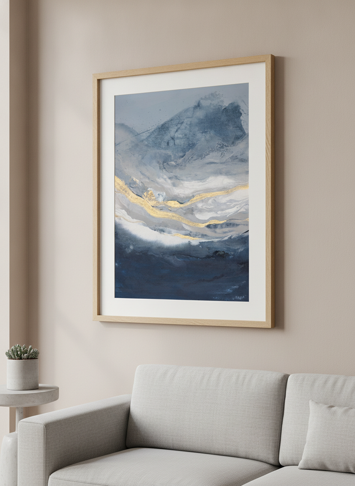 Modern wall art styled above a sofa in a neutral living room