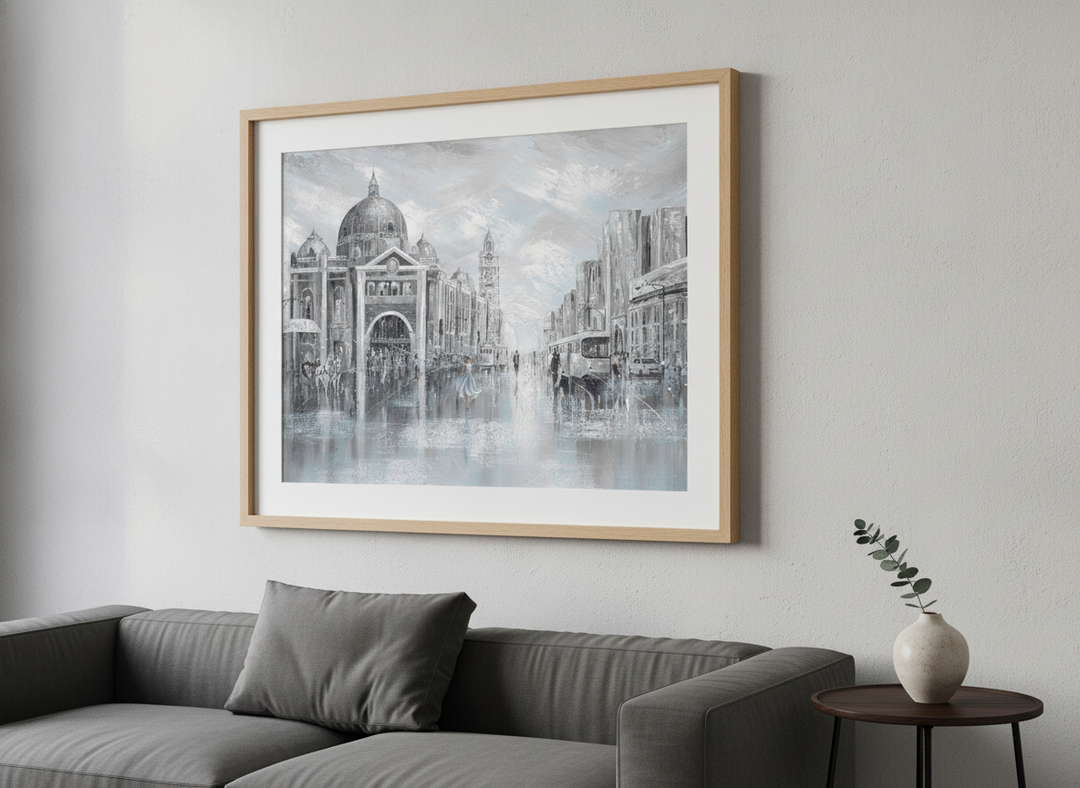 Modern wall art styled above a sofa in a neutral living room