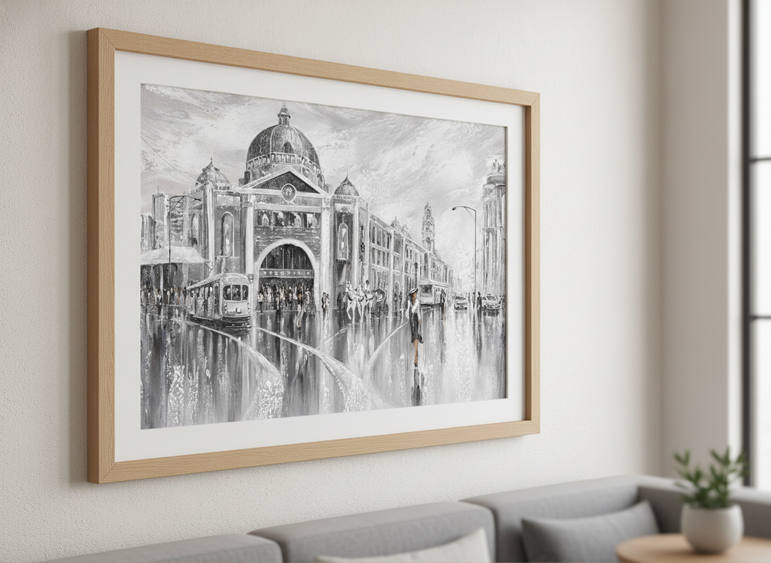 Modern wall art styled above a sofa in a neutral living room