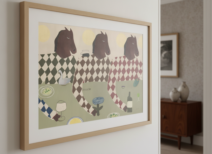 Wall art styled above a dining table in a contemporary home