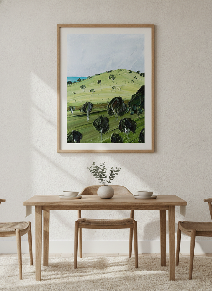 Wall art styled above a dining table in a contemporary home
