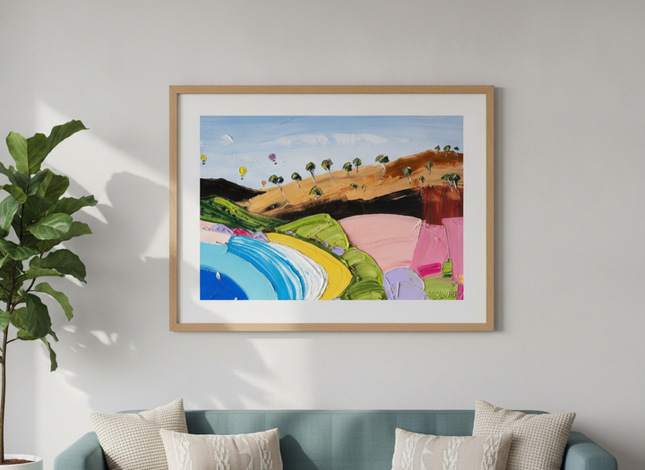 Modern wall art styled above a sofa in a neutral living room