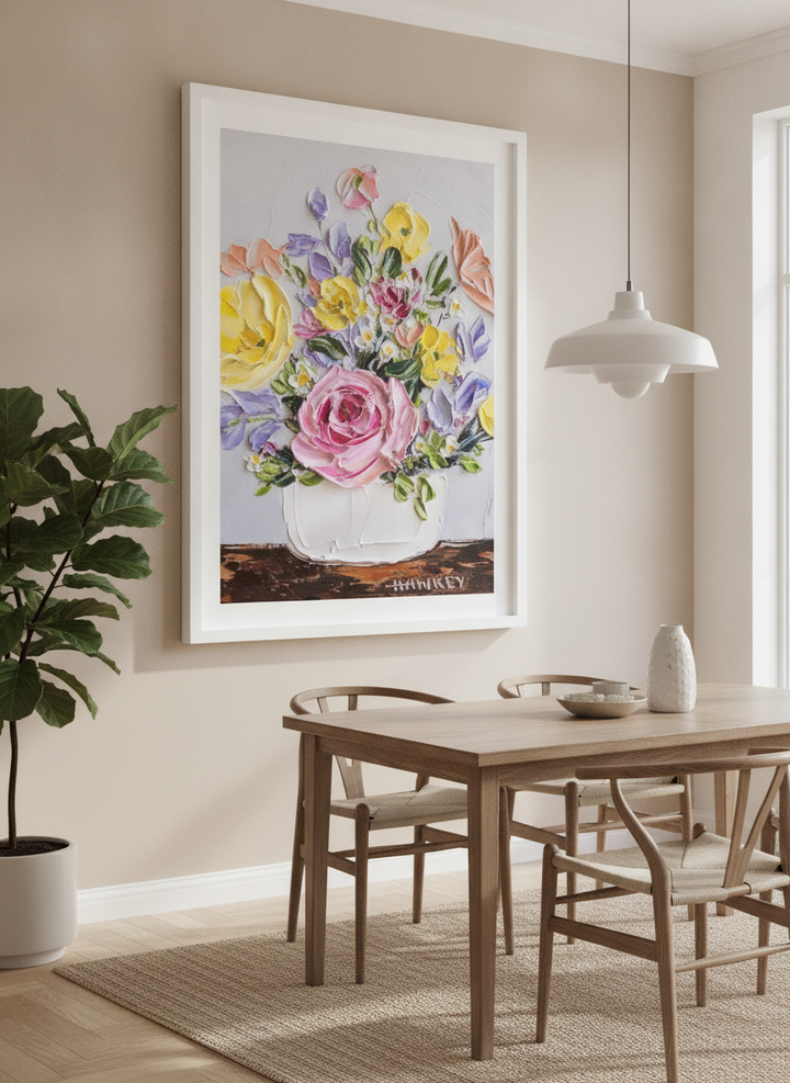 Wall art styled above a dining table in a contemporary home