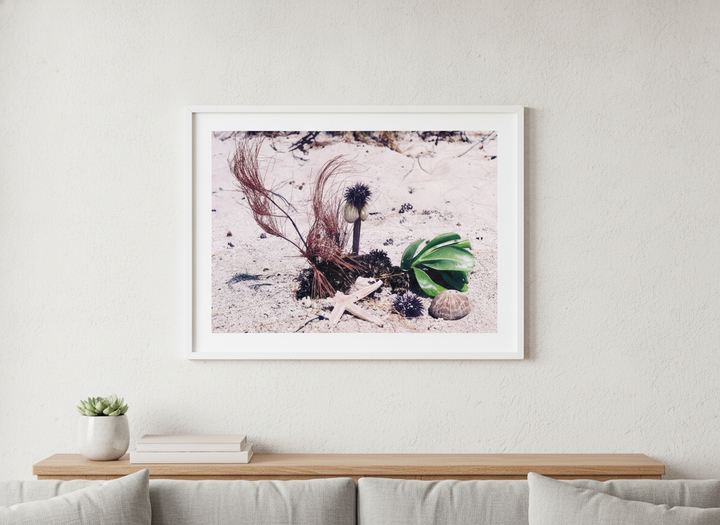 Modern wall art styled above a sofa in a neutral living room
