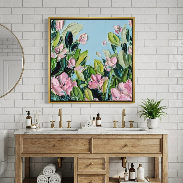 Canvas wall art with a gold leaf surround styled in a clean minimalist bathroom