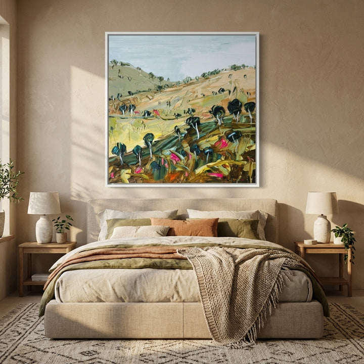 Canvas wall art with a white surround styled in a calm, light-filled bedroom