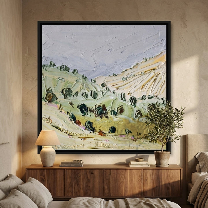 Canvas wall art with a black surround styled in a calm, light-filled bedroom