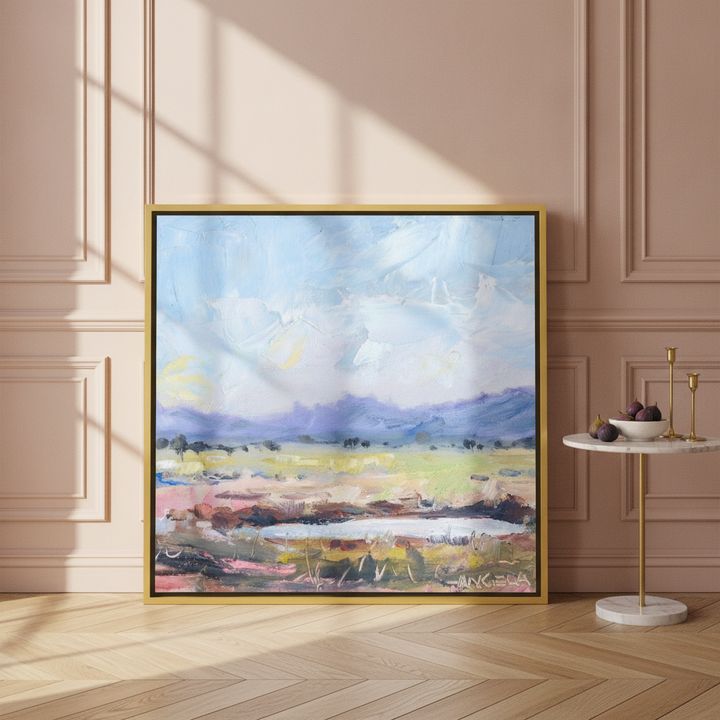 Canvas wall art with a gold leaf surround leaning against the wall in a Parisian living room