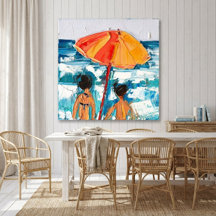 Stretched canvas wall art styled on the wall in a coastal dining room