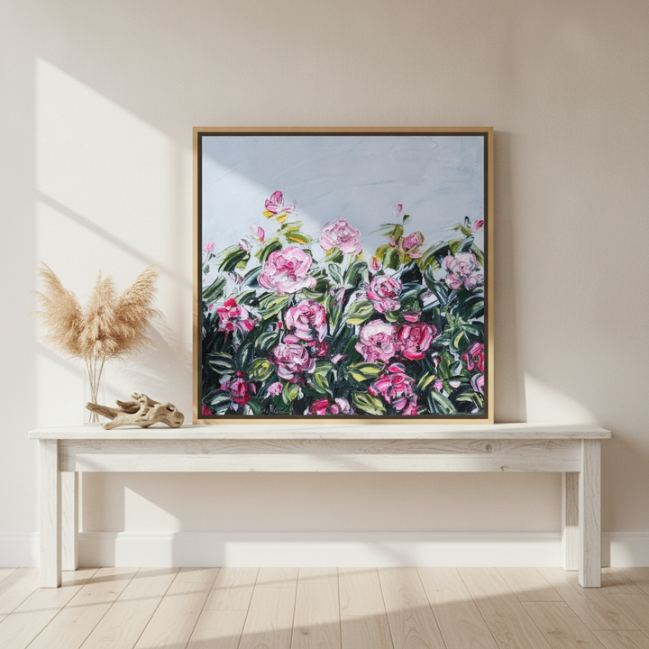 Canvas wall art with a natural timber surround standing on a console in a coastal bedroom