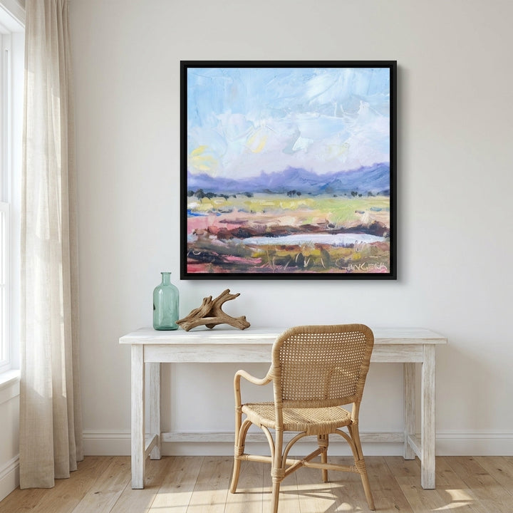 Canvas wall art with a black surround styled on the wall in a coastal home office