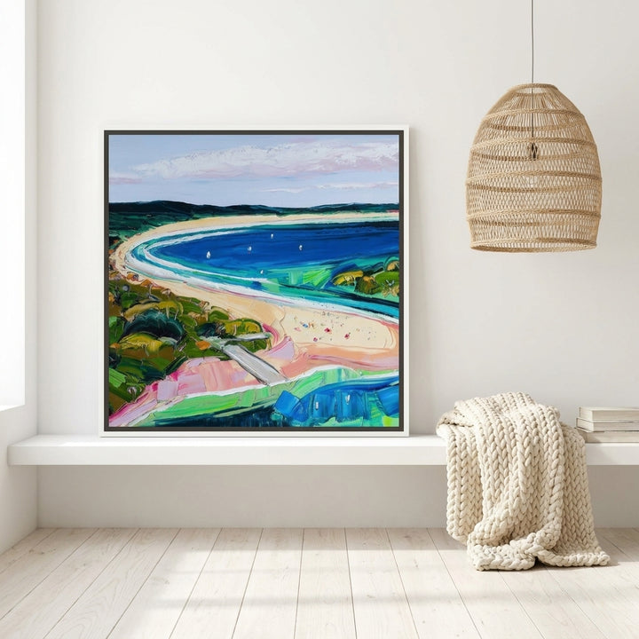 Canvas wall art with a white surround standing on a shelf in a bright Scandinavian home office