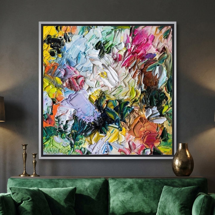 Canvas wall art with a silver leaf surround styled on the wall in a moody living room