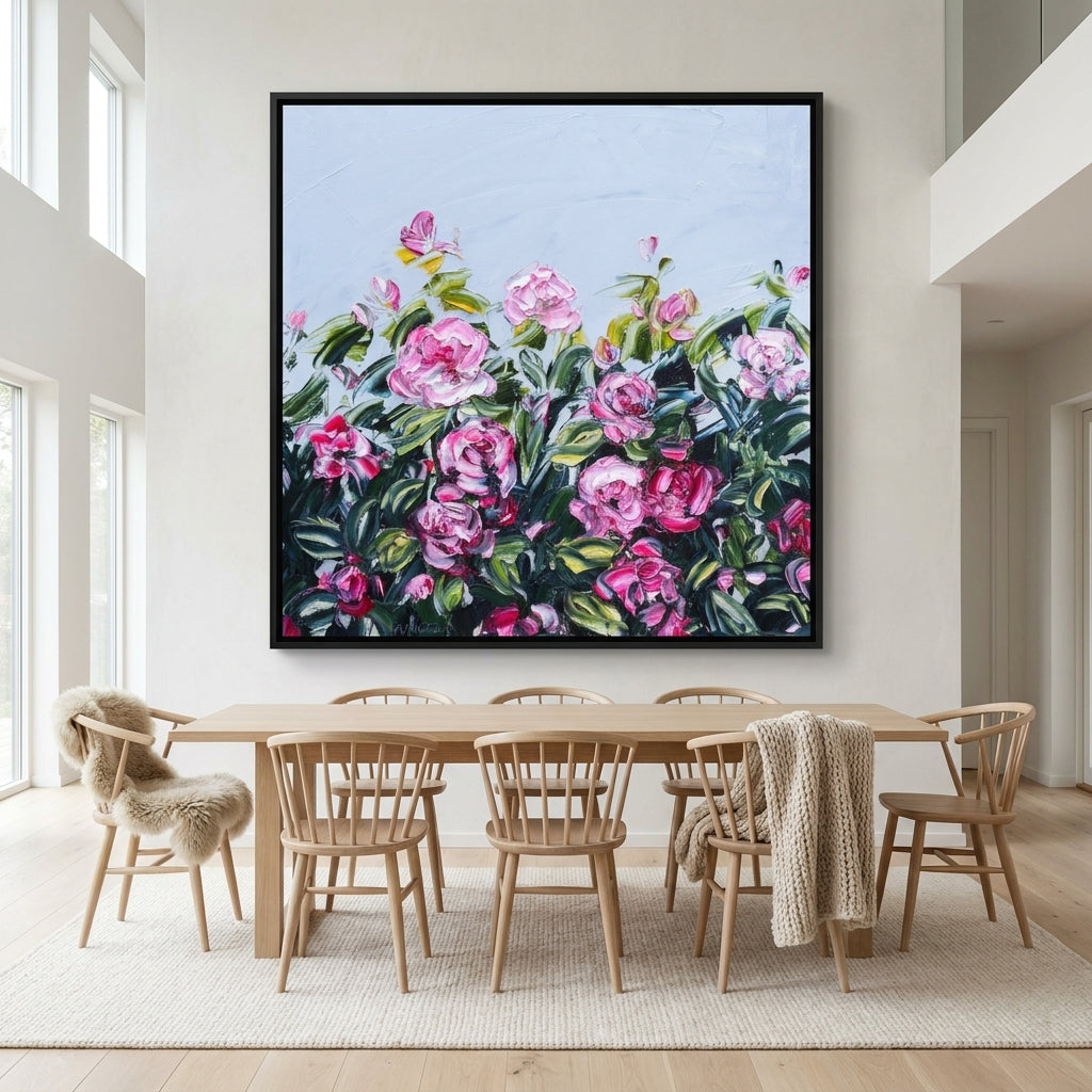Oversized statement canvas wall art with a black surround styled on the wall in a bright Scandinavian dining room