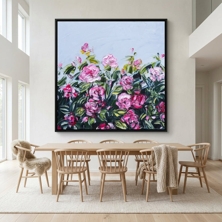 Oversized statement canvas wall art with a black surround styled on the wall in a bright Scandinavian dining room