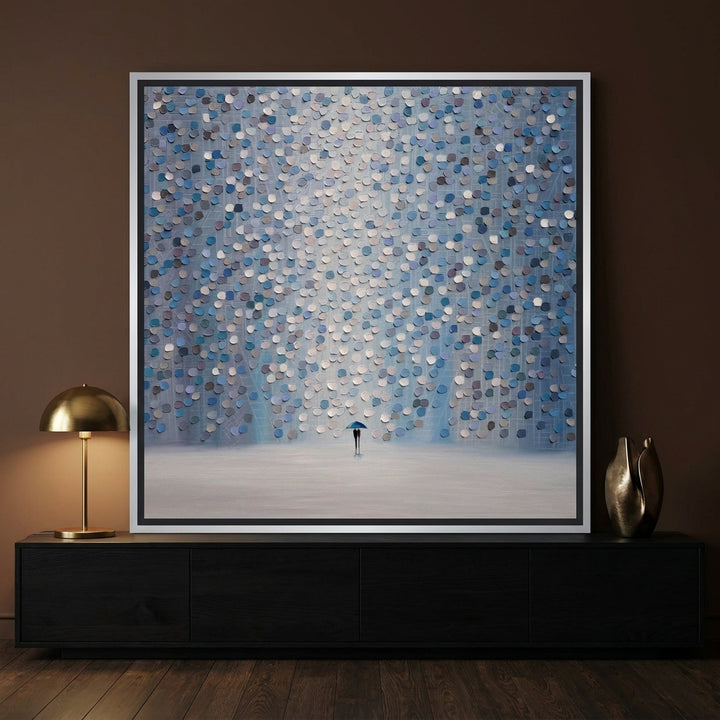 Canvas wall art with a silver leaf surround standing on a console in a moody bedroom
