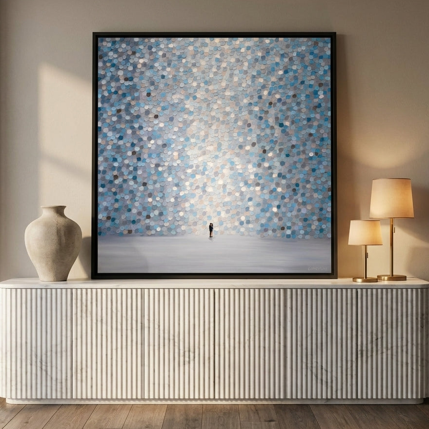 Canvas wall art with a black surround standing on a sideboard in a luxe living room